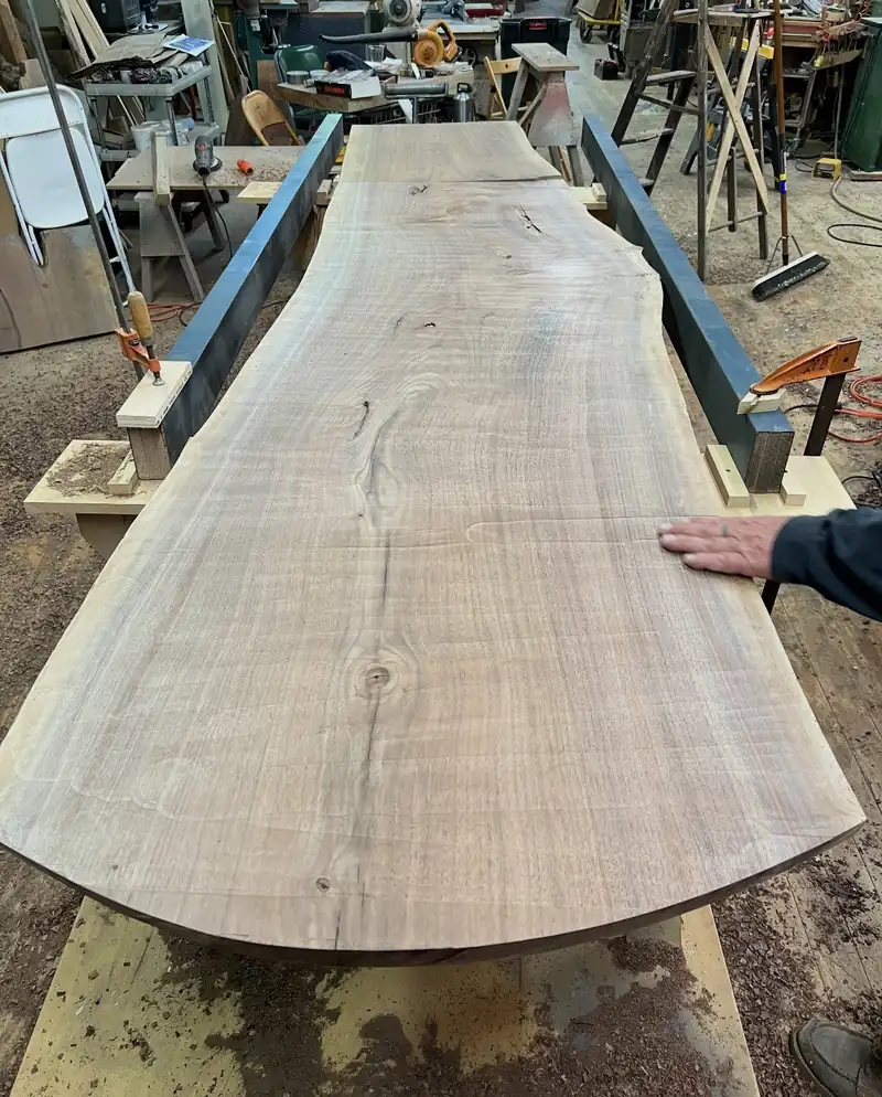 A live edge walnut slab being prepared for a custom table